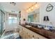 This bathroom features a vanity, a mirror, a shower and thoughtful decor at 8210 Aquila St # 218, Port Richey, FL 34668