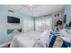 This cozy bedroom features a comfortable bed, nautical-themed decor, and plenty of natural light at 8210 Aquila St # 218, Port Richey, FL 34668