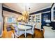 Open-concept dining area with a chandelier, and views of the kitchen, blending living spaces with style at 8210 Aquila St # 218, Port Richey, FL 34668