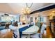 Inviting dining area connecting the living room and kitchen, with anchor-themed chairs and coastal accents throughout at 8210 Aquila St # 218, Port Richey, FL 34668