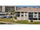Multi-story condo building with neutral color scheme, well-maintained lawn, and parking at 8210 Aquila St # 218, Port Richey, FL 34668