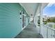 Stylish building exterior featuring a covered walkway with white pillars and beachy turquoise siding at 8210 Aquila St # 218, Port Richey, FL 34668