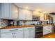 An open kitchen features white cabinetry, modern appliances, and butcher block countertops at 8210 Aquila St # 218, Port Richey, FL 34668