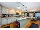 A well-equipped kitchen features an island, modern appliances, and a seamless transition to the dining area at 8210 Aquila St # 218, Port Richey, FL 34668