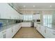 Spacious kitchen with white cabinetry, stone countertops, and stainless steel appliances at 8210 Aquila St # 218, Port Richey, FL 34668