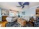 Stylish living room with a nautical theme, ceiling fan, comfortable seating, and abundant natural light, for relaxing at 8210 Aquila St # 218, Port Richey, FL 34668