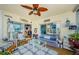 Bright sunroom with water view, wicker furniture and nautical decor at 8210 Aquila St # 218, Port Richey, FL 34668