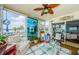 Bright sunroom with water view, wicker furniture and nautical decor at 8210 Aquila St # 218, Port Richey, FL 34668
