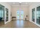 Lobby with tiled floor, glass doors, and bulletin board offers a welcoming entry at 8210 Aquila St # 218, Port Richey, FL 34668