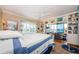A serene main bedroom offers a sitting area, water view, and coastal-themed decor at 8210 Aquila St # 218, Port Richey, FL 34668