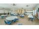 Bright meeting room with tables, chairs, kitchen, and game tables offers space for community gatherings at 8210 Aquila St # 218, Port Richey, FL 34668