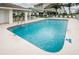 Community pool with lounge chairs and covered seating, perfect for relaxing and enjoying sunny days at 8210 Aquila St # 218, Port Richey, FL 34668