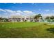 Community putting green is surrounded by grass and palm trees at 8210 Aquila St # 218, Port Richey, FL 34668