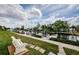 Scenic waterfront view with private boat docks, lush green landscaping, and tranquil blue skies at 8210 Aquila St # 218, Port Richey, FL 34668