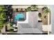 Aerial view of home with a screen enclosed pool and fenced in yard at 8600 N Briar Patch Dr, Port Richey, FL 34668