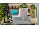 Aerial view of home with a screen enclosed pool and fenced in yard at 8600 N Briar Patch Dr, Port Richey, FL 34668