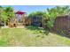 A well kept back yard area with beautiful green grass, gazebo, and wooden privacy fence at 8600 N Briar Patch Dr, Port Richey, FL 34668