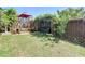 Backyard view of a sitting bench under an arbor and a wooden deck at 8600 N Briar Patch Dr, Port Richey, FL 34668