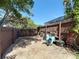 Fenced in backyard with sand, a wheelbarrow, and an enclosed pool view at 8600 N Briar Patch Dr, Port Richey, FL 34668