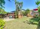 Spacious backyard with a wooden privacy fence, an in-ground pool, and green grass at 8600 N Briar Patch Dr, Port Richey, FL 34668