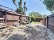 Fenced in backyard with a wheelbarrow and storage area at 8600 N Briar Patch Dr, Port Richey, FL 34668