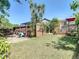 The backyard features a lawn, privacy fence and a view of the screened patio at 8600 N Briar Patch Dr, Port Richey, FL 34668
