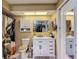 Bright bathroom featuring a vanity with marble countertop, modern fixtures, and a shower with decorative curtain at 8600 N Briar Patch Dr, Port Richey, FL 34668