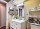 Bright bathroom featuring a new vanity with an mirrored cabinet and storage shelves at 8600 N Briar Patch Dr, Port Richey, FL 34668