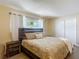 Serene bedroom featuring a window view, complemented by stylish bedside tables and modern decor at 8600 N Briar Patch Dr, Port Richey, FL 34668