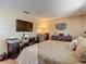 Inviting bedroom with a TV, desk, and dresser complemented by neutral decor and cozy bedding at 8600 N Briar Patch Dr, Port Richey, FL 34668