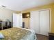 Comfortable bedroom featuring wood-look flooring, closet, and mounted television at 8600 N Briar Patch Dr, Port Richey, FL 34668