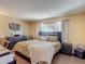 Comfortable bedroom featuring a decorative headboard, dresser, and coordinated bedside tables at 8600 N Briar Patch Dr, Port Richey, FL 34668