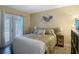 Well-lit bedroom with sliding glass doors, complemented by stylish bedding and modern decor at 8600 N Briar Patch Dr, Port Richey, FL 34668