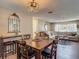 Charming dining area with a wood table, seating for four, and a decorative mirror and lighting fixture at 8600 N Briar Patch Dr, Port Richey, FL 34668