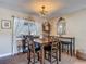 Charming dining area featuring a wooden table, comfortable chairs, and stylish decor elements, lit by natural light at 8600 N Briar Patch Dr, Port Richey, FL 34668
