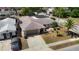 An aerial shot of a charming single-Gathering house featuring a well-manicured lawn and an attached garage at 8600 N Briar Patch Dr, Port Richey, FL 34668