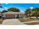 Charming single-story home featuring a two-car garage, well-maintained landscaping, and a welcoming front entrance at 8600 N Briar Patch Dr, Port Richey, FL 34668