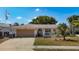 A charming single-story home with an attached garage, a front porch, and a beautifully landscaped yard at 8600 N Briar Patch Dr, Port Richey, FL 34668