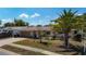 A well-maintained single-story home featuring mature landscaping, an attached garage, and a cozy front porch area at 8600 N Briar Patch Dr, Port Richey, FL 34668