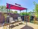 Outdoor seating area with a gazebo, patio furniture, and a wooden privacy fence at 8600 N Briar Patch Dr, Port Richey, FL 34668