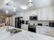 Modern kitchen featuring white marble countertops, subway tile backsplash, and stainless steel appliances at 8600 N Briar Patch Dr, Port Richey, FL 34668