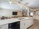Kitchen island overlooking the living room, complete with a sink, and dishwasher at 8600 N Briar Patch Dr, Port Richey, FL 34668