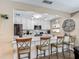 Modern kitchen with stainless steel appliances, white cabinets, and bar seating for a contemporary feel at 8600 N Briar Patch Dr, Port Richey, FL 34668