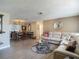 Comfortable living room featuring a large sectional sofa, round coffee table, and adjoining dining area at 8600 N Briar Patch Dr, Port Richey, FL 34668