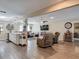 Open concept living room featuring hardwood floors, modern furniture, and a cozy fireplace at 8600 N Briar Patch Dr, Port Richey, FL 34668
