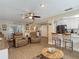 Open-concept living space with a bar, kitchen, and comfortable seating, perfect for modern living at 8600 N Briar Patch Dr, Port Richey, FL 34668