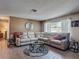 Spacious living room with a comfortable sectional sofa, stylish coffee table, and plenty of natural light at 8600 N Briar Patch Dr, Port Richey, FL 34668