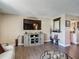 Well-decorated living room featuring a large TV, stylish furniture, and a view into the dining area at 8600 N Briar Patch Dr, Port Richey, FL 34668