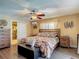 Well-lit main bedroom with a ceiling fan, closet, and wood-look flooring, comfortable and stylish at 8600 N Briar Patch Dr, Port Richey, FL 34668