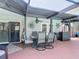 Covered patio with dining table and outdoor cooking area at 8600 N Briar Patch Dr, Port Richey, FL 34668